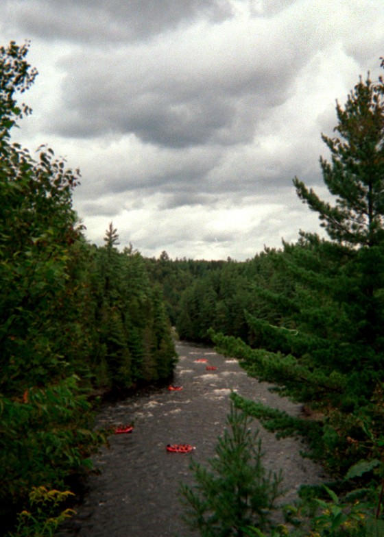 Orange boats fill the Kennebec River, a popular spot for whitewater rafting inThe Forks, Maine.
