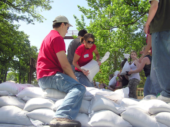 Volunteers, including students from a dance school, add sandbags Tuesday to the temporary dike built in downtown Fargo, N.D.