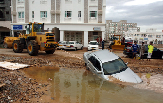 A bulldozer pulls a partially submerged