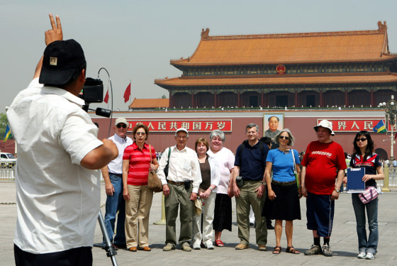 Western tourists pose for group photo at
