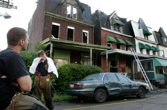 Pittsburgh firefighters take a break after fighting a fire early Tuesday that killed five children.