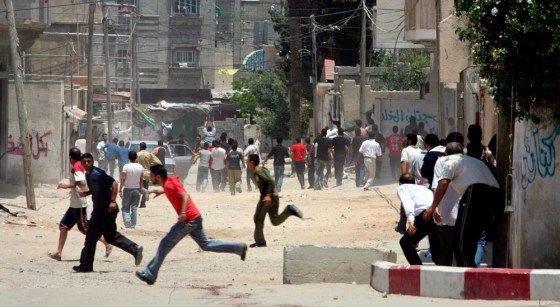 Palestinians run for cover with a car to the hospital