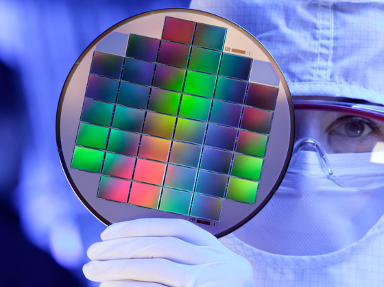 An unidentified technician showing image sensors embedded on a silicon wafer at Eastman Kodak Inc., in Rochester, N.Y.