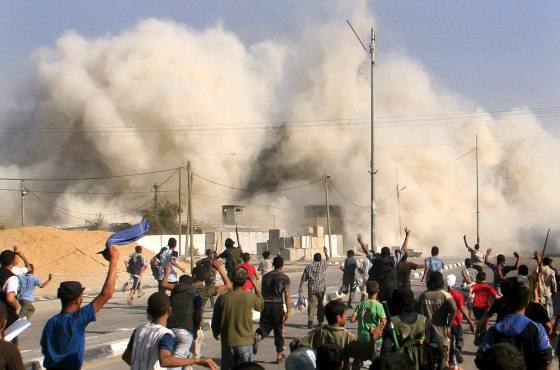Palestinians celebrate after Hamas blew up the formerly Fatah-controlled headquarters of the Preventive Security in Rafah, in the southern Gaza Strip, on Thursday.