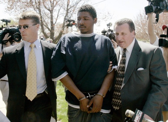 Suspect Jesse Dee Wise (C) is escorted into district magistrate's office in Leola