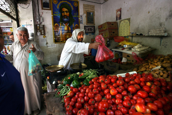 Iraqis shop at a market in central Baghdad on Sunday after four-day curfew was lifted.