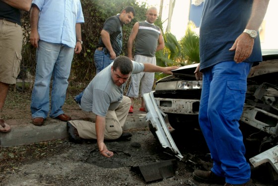 Israelis examine damage after a rocket fired from Lebanon hit the northern Israeli town of Kiryat Shmona on Sunday.