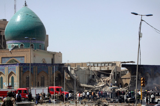 Residents gather at the site of a bomb attack in Baghdad