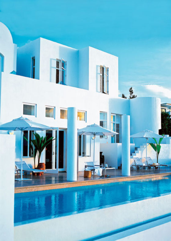 sit on a low bluff overlooking Long Bay, with private beach access and views of the surrounding islands.