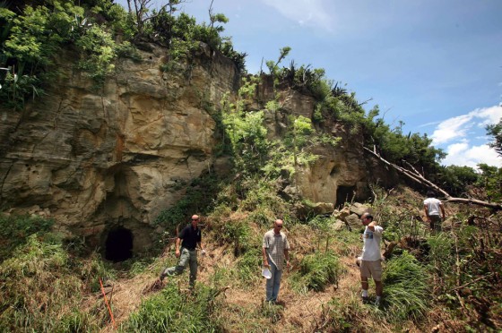 Team members from the Joint POW and MIA accounting command walk outside two cave openings on the southwestern wall of "Hill 362A" on Iwo Jima island on Wednesday.