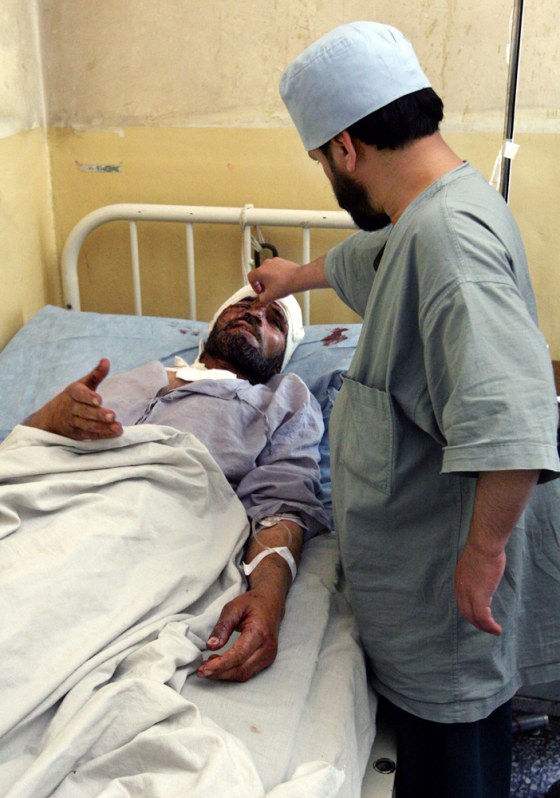 An Afghan doctor checks the wounds of a man at a hospital after a bomb blast in Kabul, Afghanistan on Sunday, June 17. The Taliban claimed responsibility.