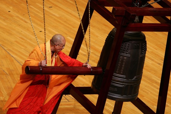 A Buddhist monk tolls a bell during a ceremony to pray for a better future in Hong Kong moments before the stroke of midnight Sunday, the 10th anniversary of Hong Kong's handover to Chinese rule from British colonial power. 