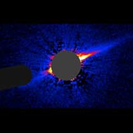 Dust and debris orbit in a needle-shaped ring that may be signs of hidden planets around the young star HD 15115 in this Hubble Space Telescope image.