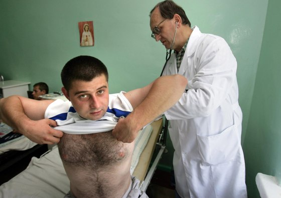 A doctor examines a patient, one of over