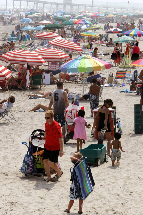 People walk on a crowded beach in Ocean City, N.J., Tuesday, July 17, 2007.