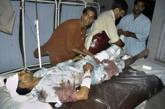 Pakistani paramedical staff give initial treatment to an injured victim of a rocket attack in Bannu, at a local hospital in Peshawar, Pakistan on Wednesday. Assailants fired four rockets into Bannu, a city in northwestern Pakistan before dawn on Wednesday.