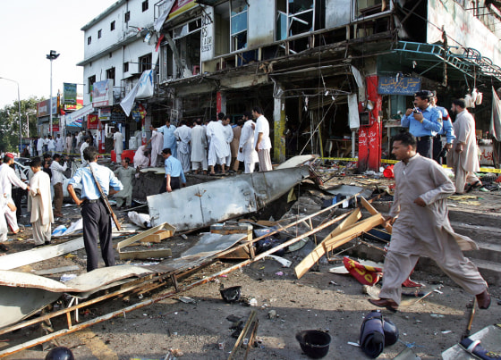 Pakistani bystanders gather around the w