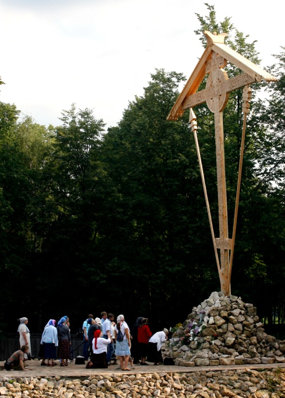 Hundreds of people laid flowers and lit candles under the 40-foot wooden cross Wednesday.