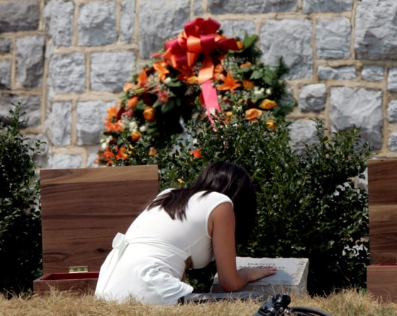 Mariella Lurch, sister of slain Virginia Tech student Daniel Alejandro Prez Cueva, pauses at his memorial stone after the dedication of the memorial for the victims of the campus shooting in Blacksburg, Va., on Sunday.