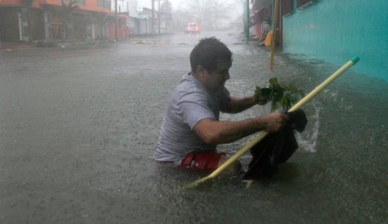 A resident tries to make his way through a flooded street in Chetumal, southeastern Mexico in the Yucatan peninsula. Hurricane Dean crashed into the Caribbean coast of Mexico on Tuesday as the strongest hurricane to hit land in the Atlantic region since 1988.