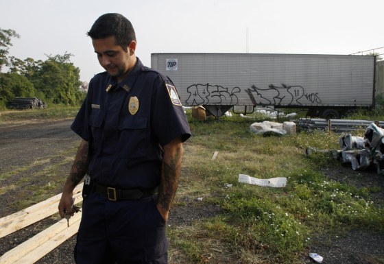 Chris Schindler, senior law enforcement officer for the Washington, D.C.,&nbsp;Humane Society, walks across a field where many injured pitbulls have been abandoned in the past after dogfights.