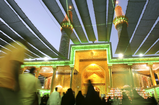 Shiite pilgrims walk outside the Imam Abbas shrine in the holy city of Karbala, Iraq on Saturday, Aug. 25. The city is preparing for a pilgrimage when hundreds of thousands of Shiite pilgrims will come to commemorate the anniversary of the birth of their 12th Imam Mahdi on Tuesday Aug 28.