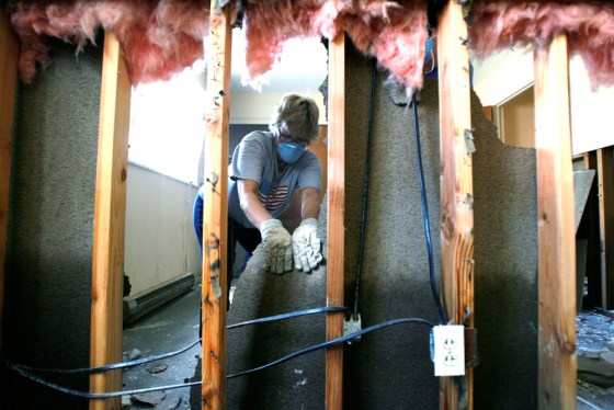 Volunteer Schroeder cleans up after banks of Blanchard River crested at seven feet above flood level in Ottawa
