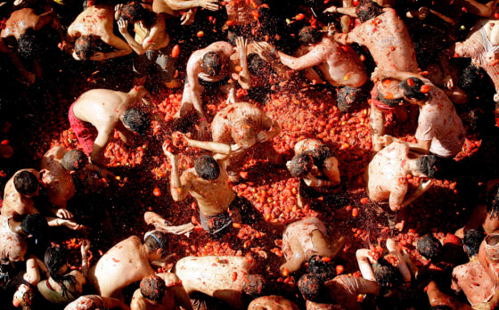 Revelers throw tomatoes at each other Wednesday during the annual food fight, the Tomatina, in the small town of Bunol, Spain.