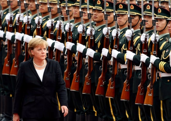 German Chancellor Angela Merkel inspects a guard of honour in Beijing