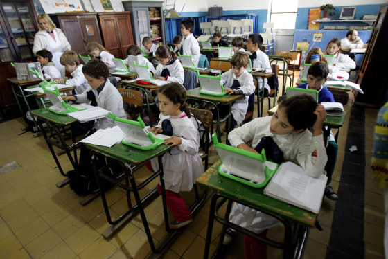 Students learn how to use laptop computers given them days earlier by the One Laptop Per Child project at a public elementary school in Villa Cardal, Uruguay. The ambitious nonprofit project, was launched in 2005.