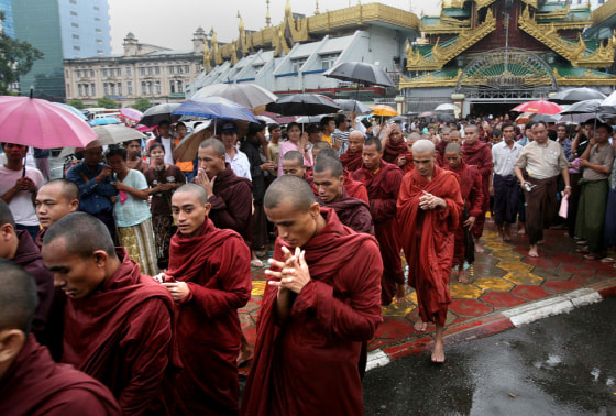 Rain-drenched Buddhist monks march in Myanmar's largest city, Yangon, on Saturday.