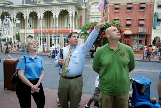 Rob Morton points out some things of note at Walt Disney World to two Miami Airport employees during a semiar on customer service.