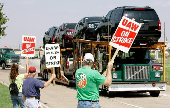 GM workers display strike signs at a plant in Arlington, Texas, Monday. Analysts expect the automaker to be able to ride out the first strike in the U.S. automotive industry since 1970, so long as it is a short one.