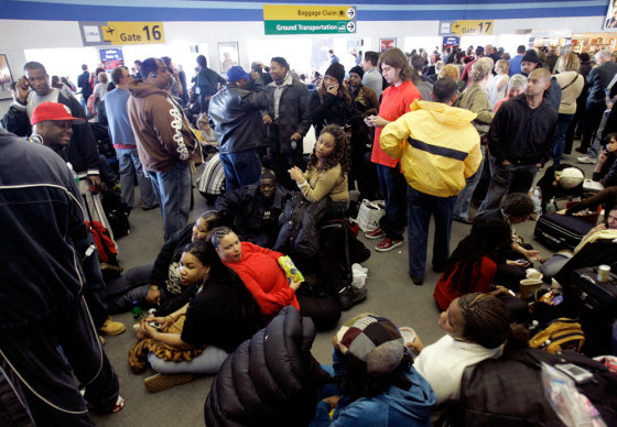 During a snow and ice storm on Feb. 15, JetBlue Airways passengers waited for flights, while onboard passengers were left waiting on planes for as long as nine hours at New York's Kennedy Airport. A report released by the DOT Tuesday makes several suggestions to deal with delays and burdened passengers — but proposed no penalties for failure to comply.