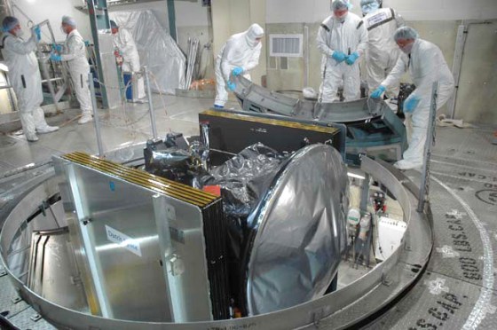 Launch pad workers prepare the Dawn spacecraft for its attachment to a Delta 2 rocket. A possibility of rain showers on launch day could delay Dawn's liftoff, NASA mission managers said.
