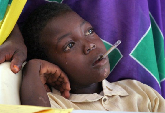 A young boy diagnosed with malaria awaits treatment Wednesday at a clinic run by World Vision in a Darfur, Sudan, refugee camp. The U.S.-based group has been affected by a recent surge of violence in Darfur.