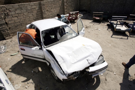 Hussam Hassan inspects his father's car, which was damaged in the shooting incident involving Blackwater USA security guards on Sept. 20, in Mahmoudiya, south of Baghdad. At least 11 Iraqis died in the incident.