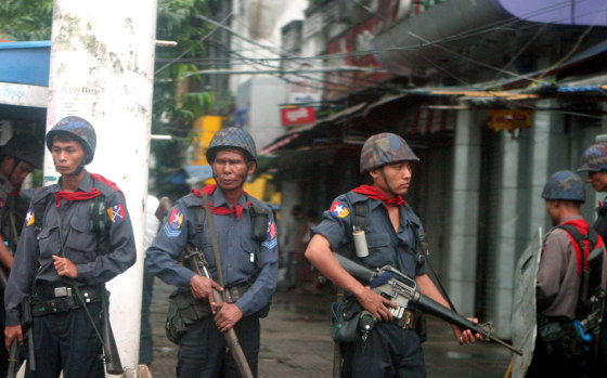 Soldiers take their positions along a street to quell defiant protesters who gathered in pockets to continue protests against the military junta Saturday in Yangon, Myanmar.