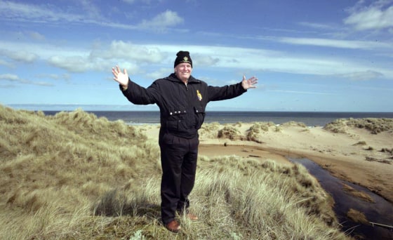 Donald Trump stands on Scottish dunes that have become a battleground over his plans for a golf resort.