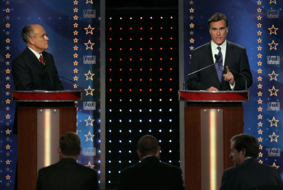 Republican presidential candidate Giuliani listens as Romney makes a point during debate in Orlando