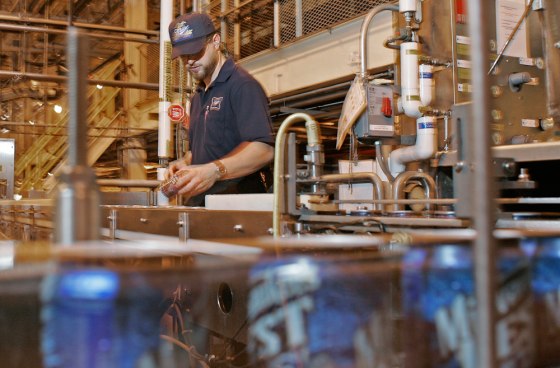 Miller brewery worker Steve Greene looks over cans as they go by on the line at Miller Brewing Company earlier this month.Miller Brewing Co., the Milwaukee brewer that gave the world light beer, celebrates its 150th birthday next month.