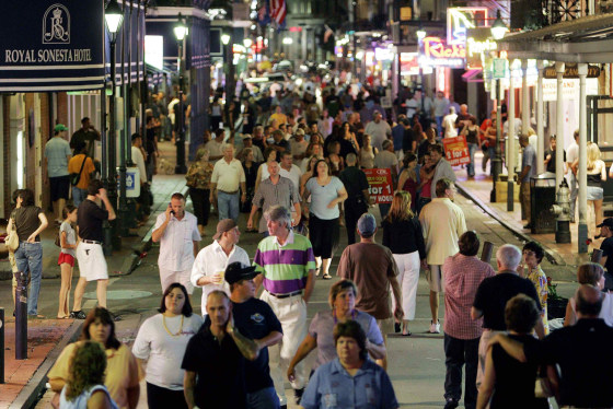 Tourists walk on Bourbon street in the French Quarter neighborhood of New Orleans