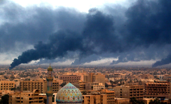 Smoke billowing from burning oil trenches covers Baghdad on April 2, 2003. Russian intelligence reportedly told Saddam Hussein of plans for that day's attack.