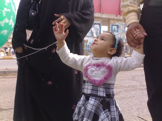 Nour, 2, leaves a Baghdad amusement park with her parents on Friday. Fear of bombs led Nour’s parents to cut short one of their daughter’s rare trips out of her home.