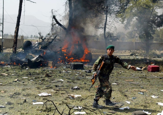 An Afghan soldier guards the site of a suicide car bomb in Kabul on Friday.