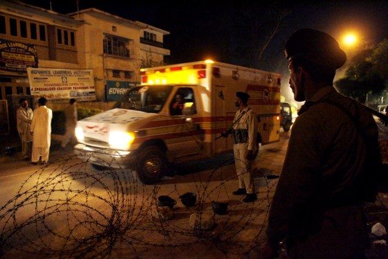Ambulances cross through a military checkpoint as they leave the area of the Lal Masjid, or Red Mosque in Islamabad, Pakistan, on Tuesday.