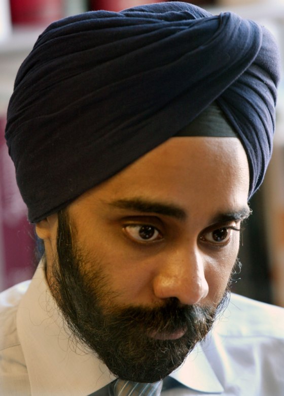 Amardeep Singh, executive director The Sikh Coalition in New York, reviews documents at his office in New York. A new airport screening policy for turbans and other headwear has the country's Sikhs concerned they are being unfairly targeted.