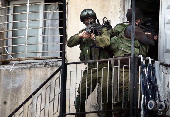 Israeli soldiers search a building durin