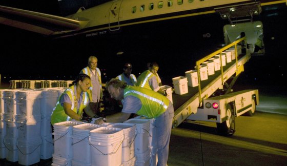 Ground crew members unload more than 17 tons of silver coins found aboard a shipwreck in the Atlantic Ocean. A Spanish court has ordered police to search two vessels belonging to the treasure-hunters. 