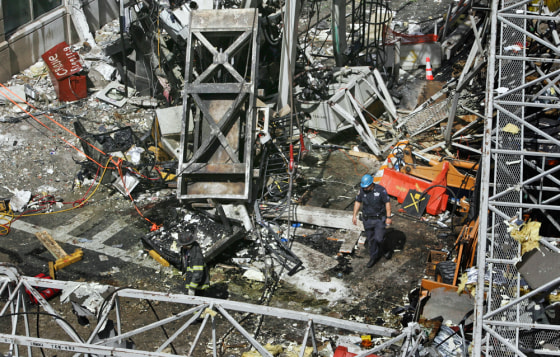 Rescue workers look through wreckage after a construction crane collapsed on New York's Upper East Side on May 30, 2008. It was the second deadly crane accident in 2 1/2 months in the city.
